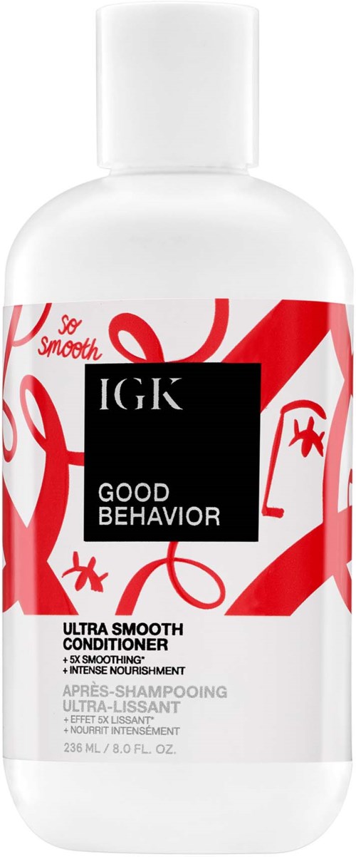 Een witte fles met IGK Good Behavior conditioner met rode abstracte lijnen en zwarte tekst.