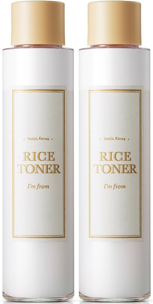 Twee witte flessen met de tekst 'Rice Toner' en beige doppen staan naast elkaar.