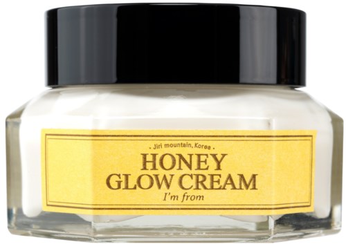 Een klein potje met zwarte deksel en geel label genaamd Honey Glow Cream, van Jiri-berg, Korea.