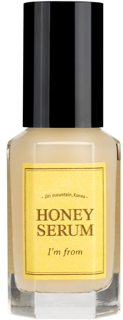 Een doorzichtige flesje honingserum met een zwarte dop en geel label, met tekst uit Jiri Mountain, Korea.