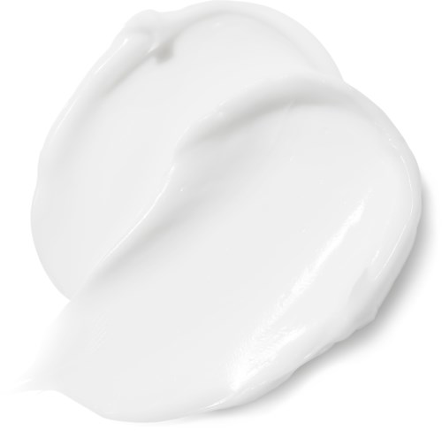 Witte crème of lotion verspreid over een oppervlak, glanzend en glad.