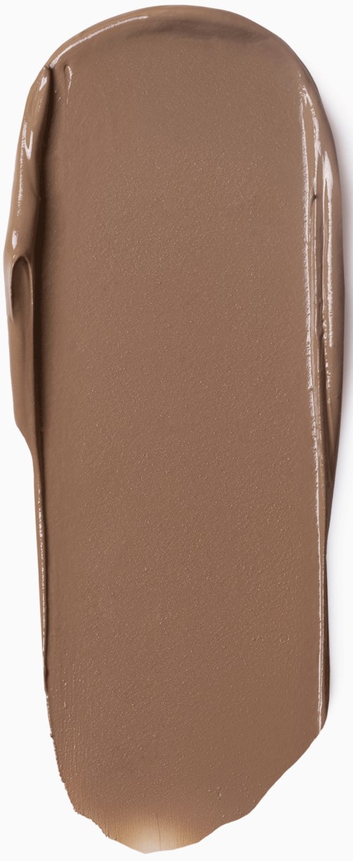 Een strook bruin romig materiaal, glad en langwerpig, waarschijnlijk een make-up- of chocoladeproef.