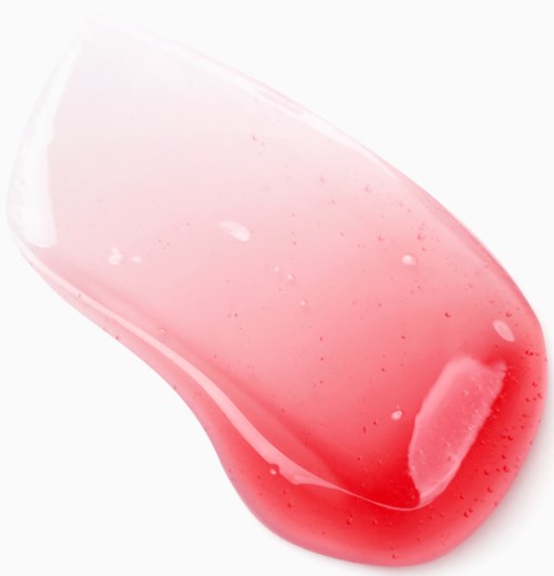 Eine rosa gelartige Substanz auf einer weißen Oberfläche, mit einer transparenten, gebogenen Form und kleinen Blasen.