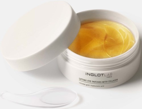 Vit burk med Inglot lab lyftande ögonlappar med guldfärgad gel inuti och en spatula.