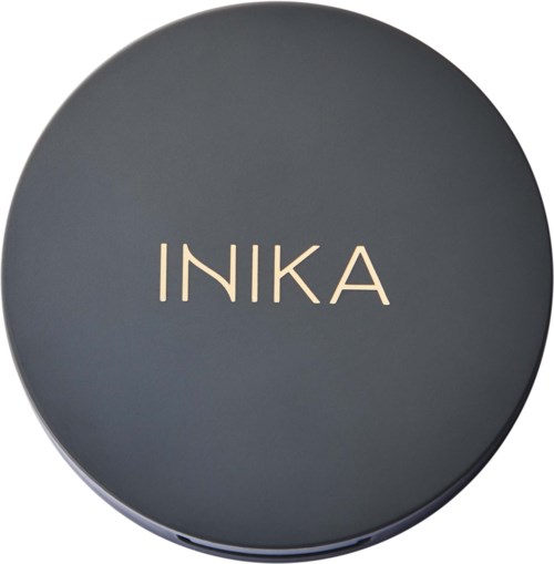 A round, dark-colored container lid with the word 'INKA' in the center.