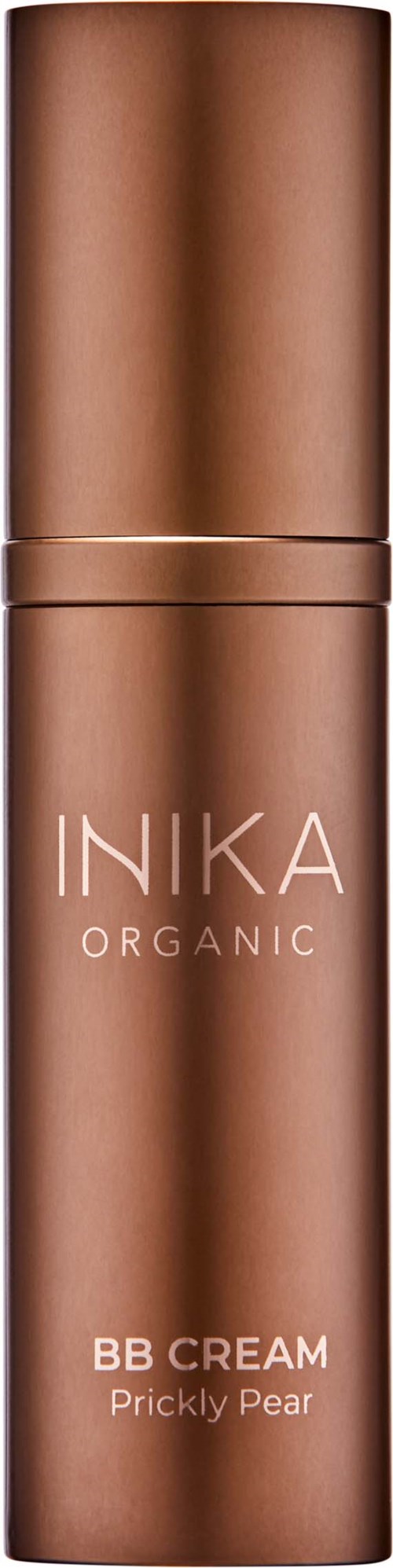 A brown cylindrical bottle labeled INIKA ORGANIC BB CREAM Prickly Pear against a black background.