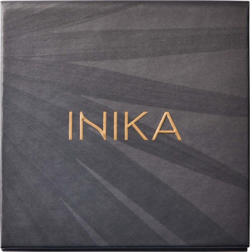 Design with name 'INIKA' on a dark textured background, simple elegance. Likely a product or logo box.
