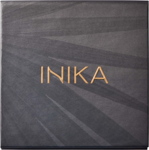 A black box with the word "INIKA" in gold letters on the front.
