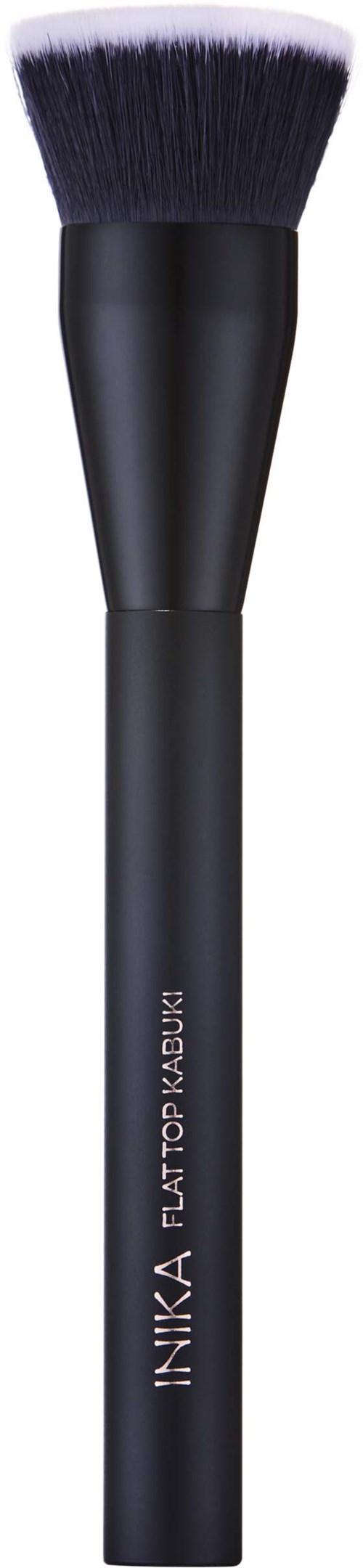 A black makeup brush with dense black and white bristles and a rounded tip.