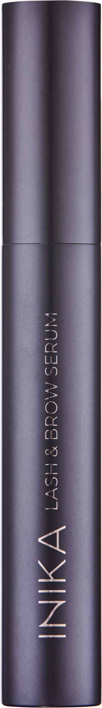 A tall, dark, sleek cylindrical bottle with the brand name INIKA and the words Lash & Grow Serum.