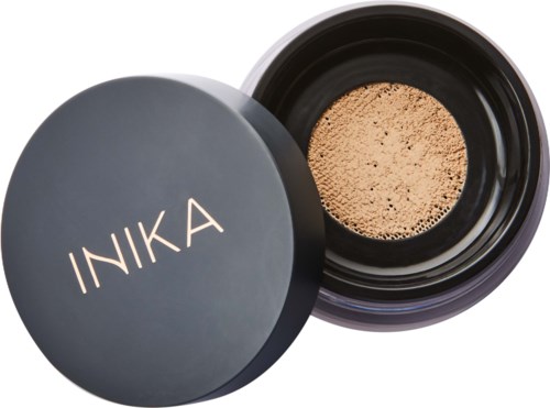 A container with powder inside and a lid with the brand name 'INKA' on it.