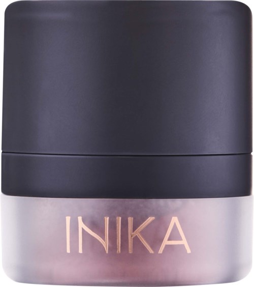 A small, round, gray container with pink text saying "INIKA" on the front. The lid is dark gray.
