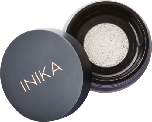 A round container with a lid shows the brand name INIKA; the container is open, revealing a white powder inside.