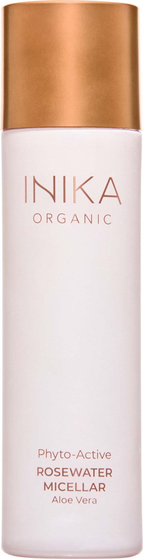 A white bottle with a gold cap labeled 'INIKA ORGANIC,' containing rosewater micellar with aloe vera.