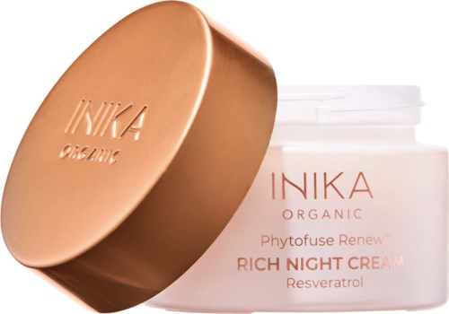 A white jar labeled Inika Organic Phytouse Renewal Rich Night Cream with Resveratrol, next to a gold-colored lid.