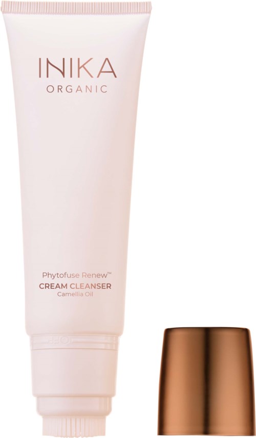 En tube med INIKA Organic Phytoplex Renew Cream Cleanser med kobberfarget lokk ved siden av.