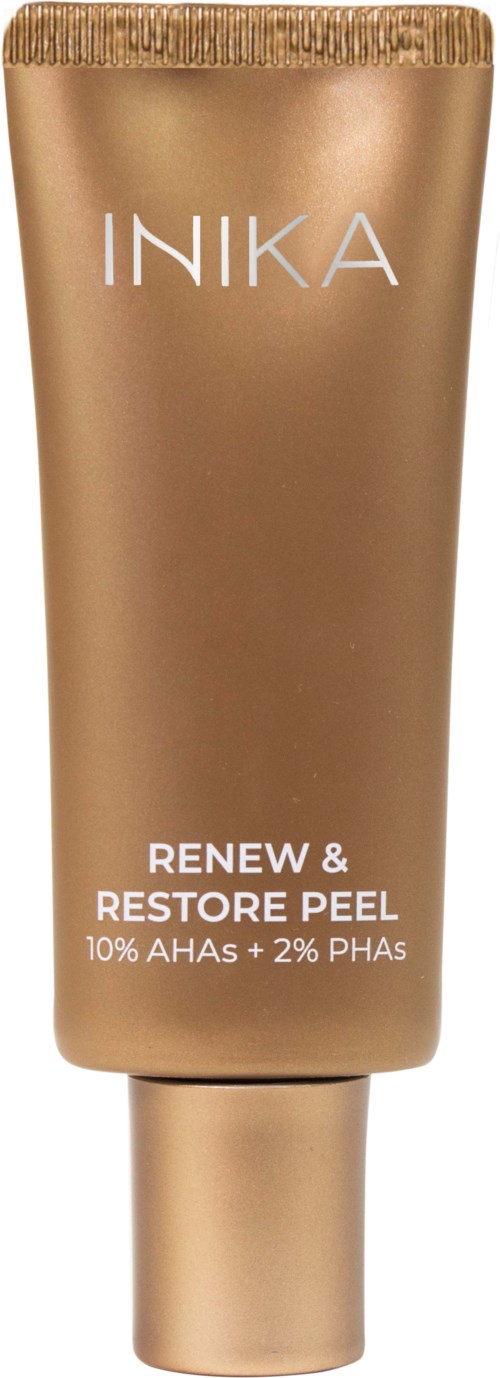 A gold-colored tube of INIKA skincare product labeled 'Renew & Restore Peel' with 10% AHAs and 2% PHAs.