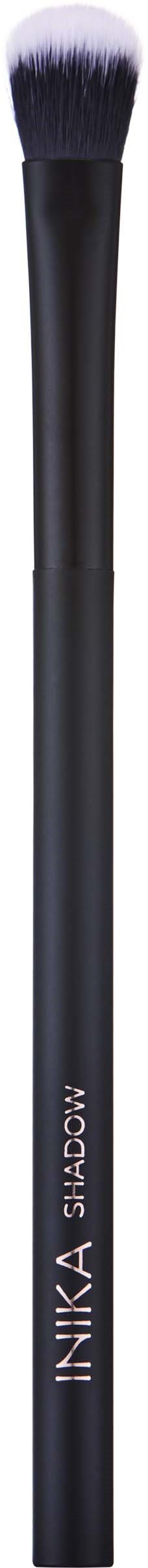 A makeup brush with a dark handle and fluffy white-tipped bristles.