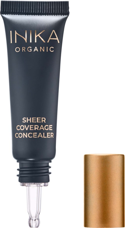 A tube labeled "INIKA ORGANIC SHEER COVERAGE CONCEALER" with a cap beside it.