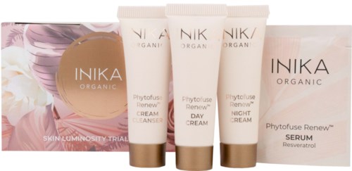 A skincare set includes evening and morning creams, a serum, and a trial box with floral and gold design elements.