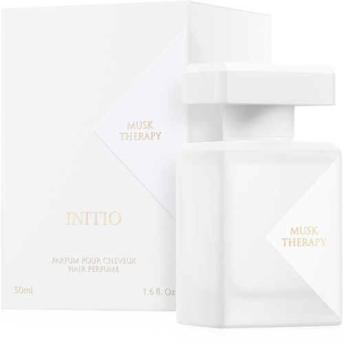 Weiße Box mit goldener Schrift und Parfümflasche mit der Aufschrift 'INITIO Musk Therapy' und 'Parfum pour cheveux.'