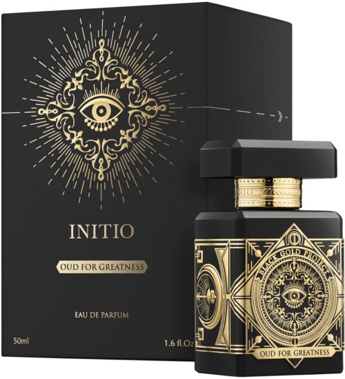 Eine luxuriöse Parfüfflasche mit Gold-Designs und Augensymbol, neben einer passenden schwarzen Verpackung mit goldenen Akzenten.