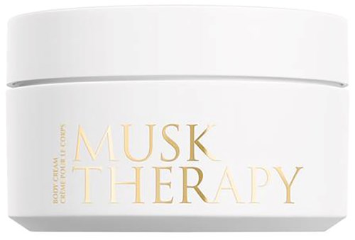 A white jar labeled 'Musk Therapy' with gold letters, likely a body cream container.