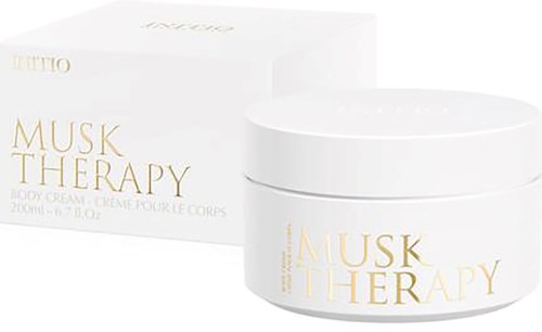 A white jar of Musk Therapy body cream with gold text, and a matching white box with similar design.