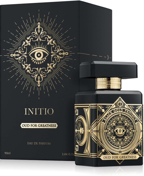 Eine schwarze Parfüfpackung mit Golddesign und Augensymbol, sowie eine passende Schachtel mit ähnlichem Goldmuster und Augensymbol.