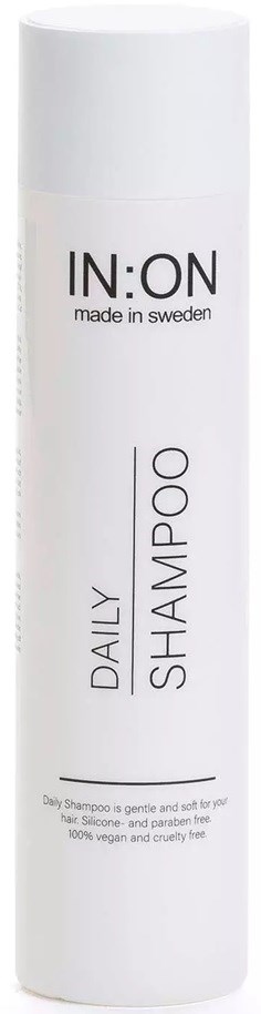White cylindrical bottle labeled IN:ON daily shampoo made in Sweden with minimalist design.