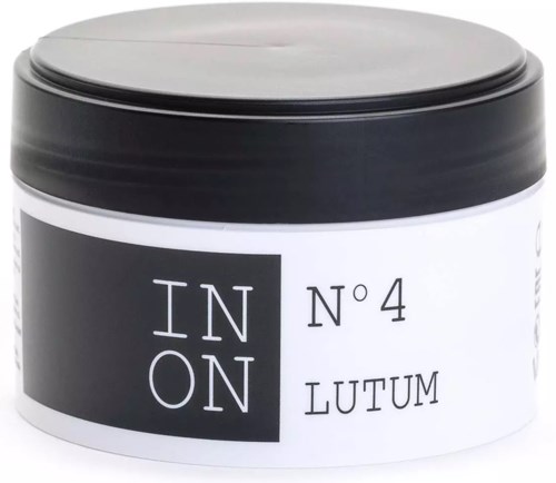 A black and white jar labeled IN ON No 4 LUTUM, likely a cosmetic or skincare product.