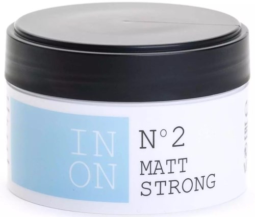 A small jar with a black lid, label saying "IN ON N 2 MATT STRONG" in black and light blue.