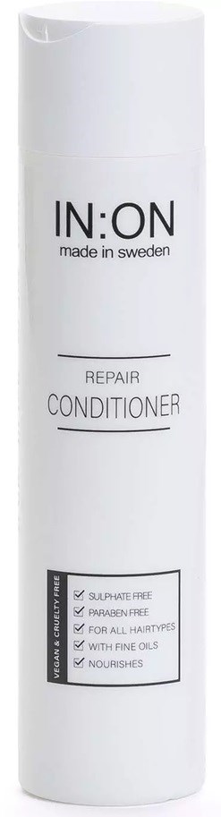 A tall white bottle labeled IN:ON Repair Conditioner, made in Sweden, with benefits like being sulfates free and nourishing.
