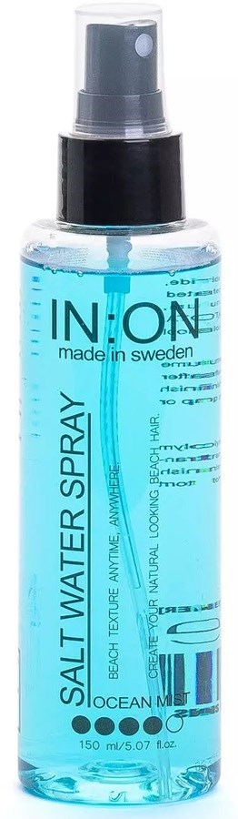 A clear spray bottle with blue liquid and black pump labeled IN.ON salt water spray for hair.