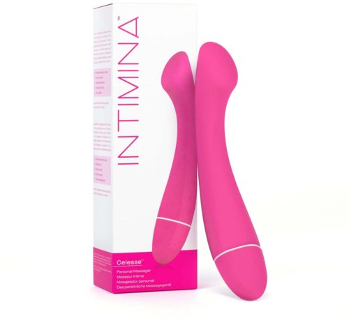 Ein pinkfarbenes Objekt mit zwei gekrümmten Armen, steht neben seiner weißen Verpackung.