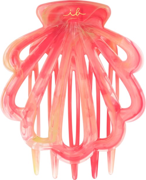 A pink hair claw clip with a gold logo on top and decorative scalloped edges.