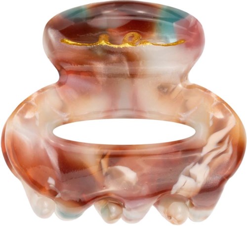 A colorful marbled object shaped like a small animal, possibly a cat or bear, with big paws and an open mouth.