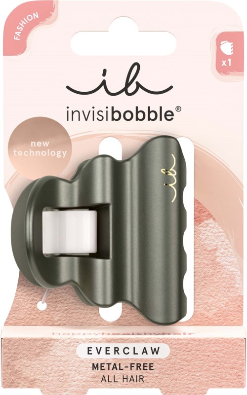 A small black hair clip with a wavy design, attached to pink and white packaging labeled 'invisibobble' and 'Everclaw'.