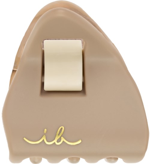 A beige prosthetic foot with a white heel cap and a yellow signature logo. Smooth surface and rounded shape.