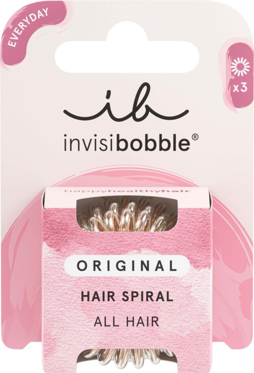 Bildet visar ett rosa och vitt paket med hårspiraler för alla hårtyper, märkt 'ib invisibobble', med några dekorativa blommor.