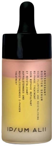 En liten flaska med svart lock, innehåller rosa och gul vätska med text på.