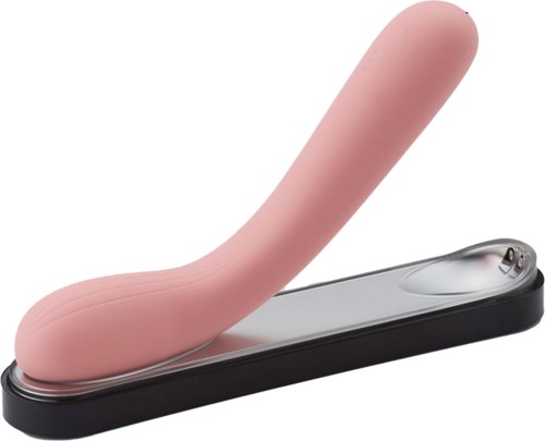 Ein pinker, gekrümmter Gegenstand auf einer schwarzen Basis, sieht aus wie ein Erwachsenen-Spielzeug, mit einem glänzenden Metallteil.