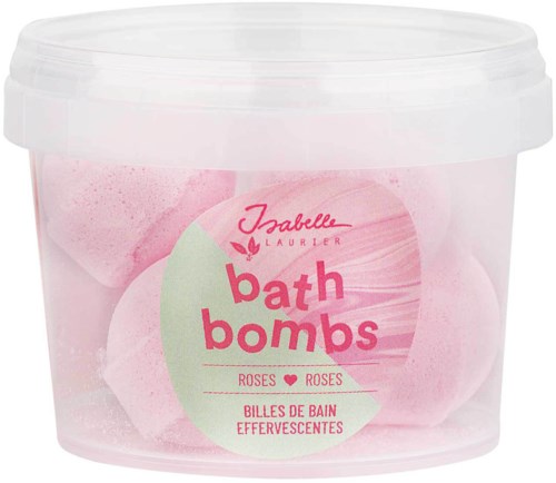 Ett tydligt behållare innehåller rosa badbomber med vita kulor inuti och en etikett med rosa och gröna texter.