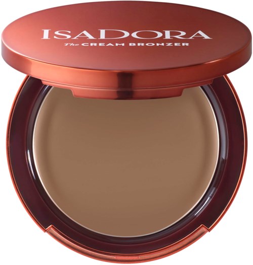 A round, open makeup compact with a brown cream product inside and a reddish cover. The cover has white text.