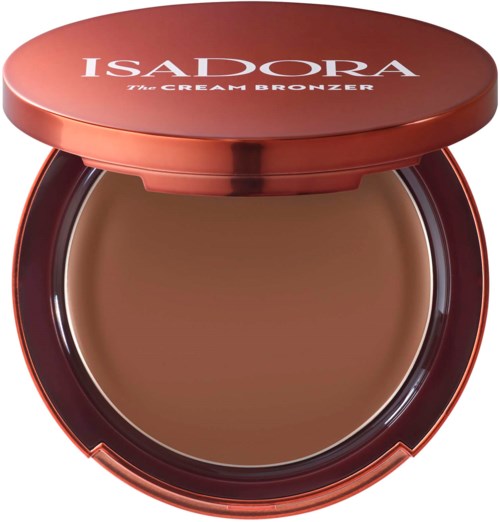 A round compact with brown cream bronzer inside, labeled with 'ISADORA The CREAM BRONZER'.