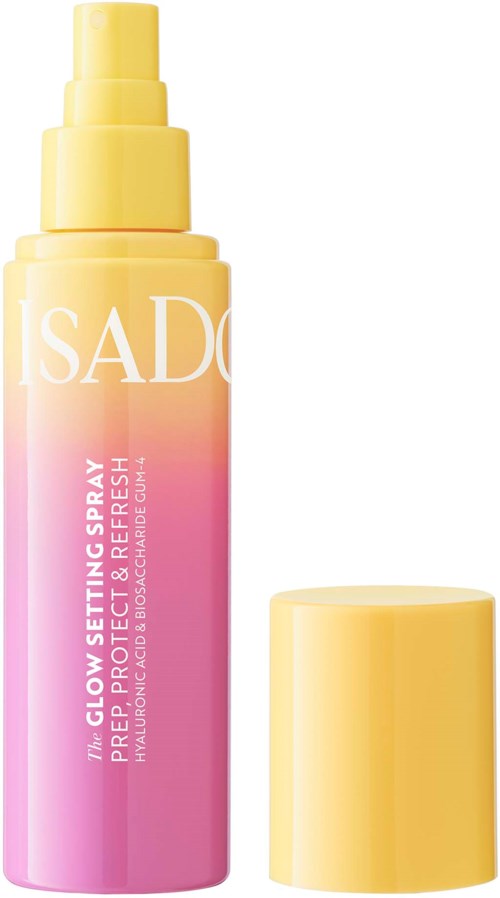A bottle of Isado glow setting spray with pink and yellow colors, and the spray cap removed.