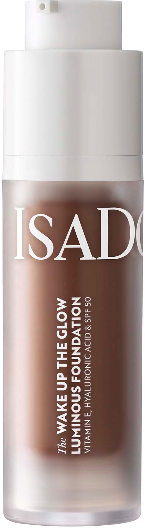 A bottle of liquid foundation with a white cap and label reading "ISAD" and "Wake Up The Glow."