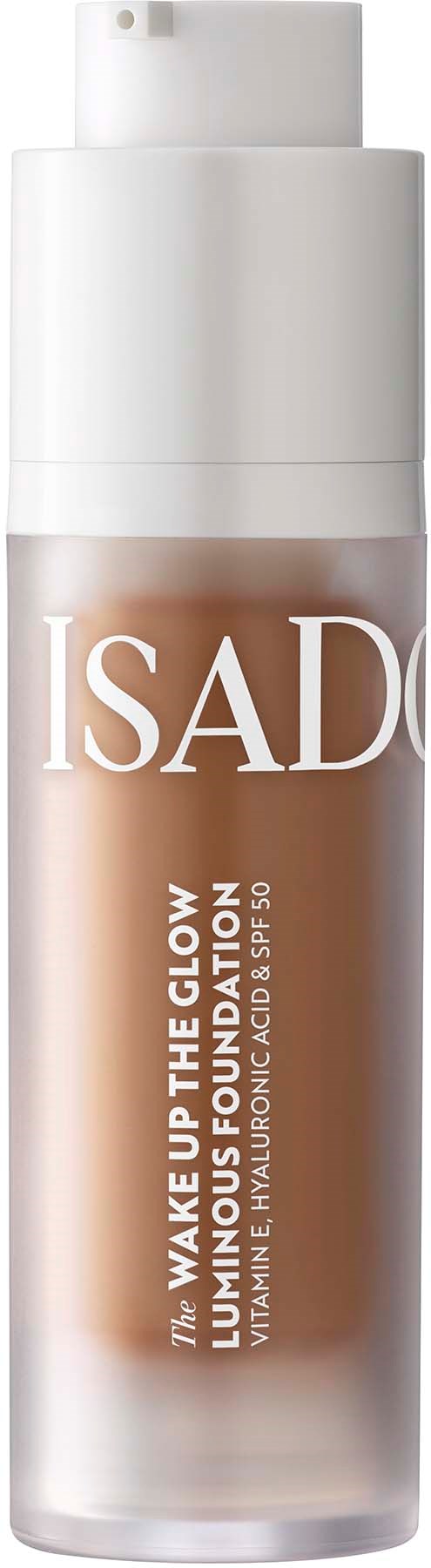 Eine Flasche Isadora Haut-Glow-Fundation mit Pumpe, beschriftet 'Wake Up The Glow'.