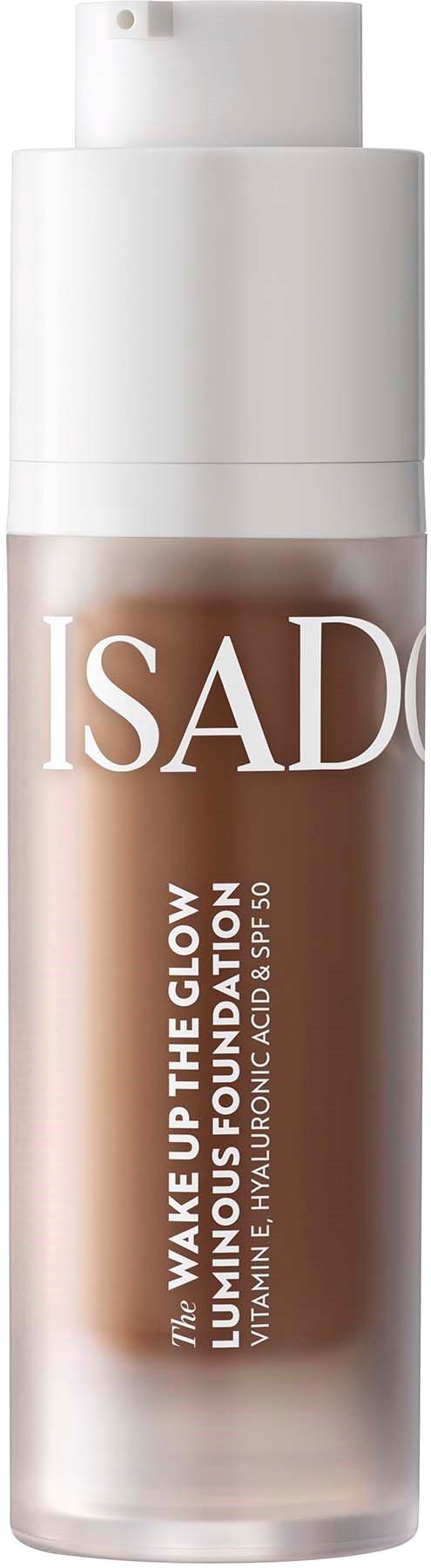 Eine zylindrische Flasche IsaDora Foundation mit Pumpkopf, beschriftet 'Wake Up The Glow', in Beigetönen.