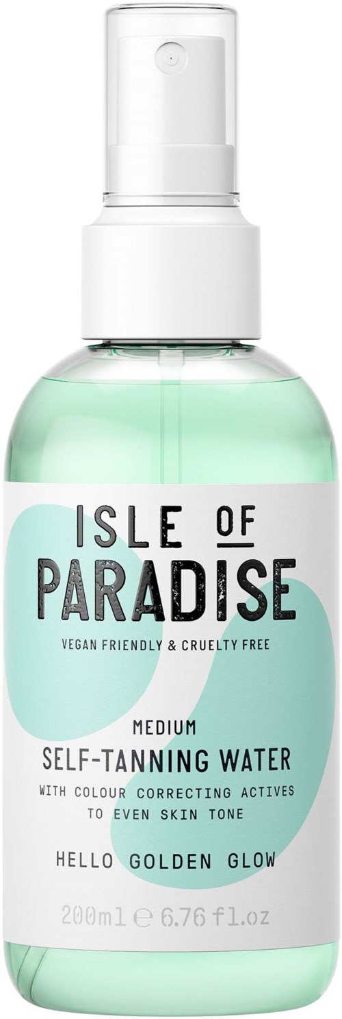 A spray bottle labeled "Isle of Paradise" with soft green liquid inside, for skin tanning, cruelty-free, with a white cap.